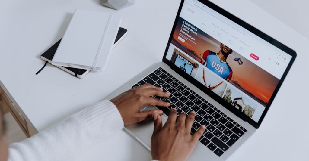 Close-up of hands typing on a laptop in a modern workspace. Minimalist, clean aesthetic.